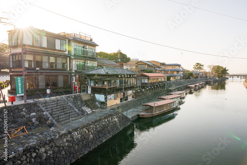 Uji, Kyoto prefecture, Japan - March 11 2023 : Scenery of Uji River. Boats for cruises on the river shore.
