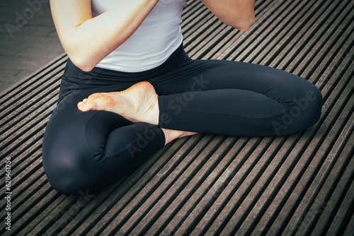 half body view of siddhasana yoga pose in an urban space