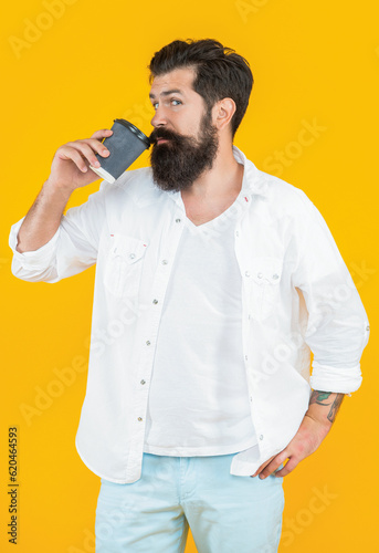 guy drink morning coffee isolated on yellow. guy with morning coffee on background.