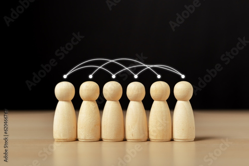 Social interpersonal connections. Online communication network. Interpersonal coordination. Human wooden figurines group with link line communication system in company organization. photo