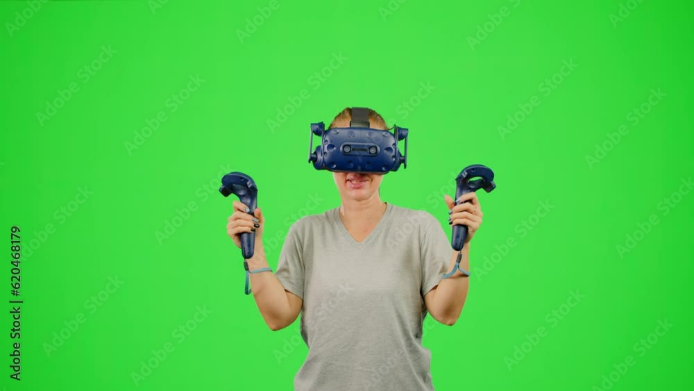 The girl wearing VR headset gaming in virtual reality boxing game.The woman fighting on chroma