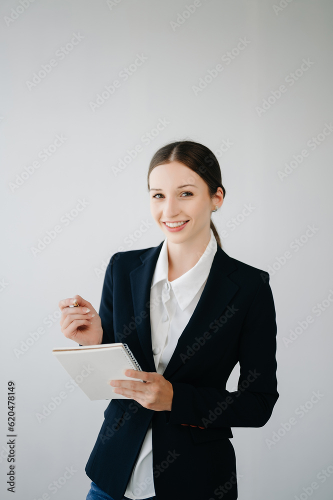 Smiling caucasian young businesswoman bank employee worker manager boss ceo looking at camera, using tablet, laptop and notepad online isolated in white background. Smiling caucasian young businesswoman bank employee worker manager boss ceo looking at camera, using tablet, laptop and notepad online isolated in white background.