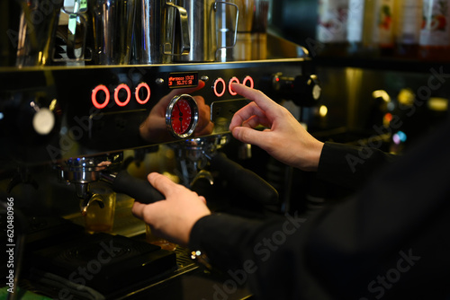 Cropped shot of barista preparing coffee for customer order in trendy coffee. Small business concept