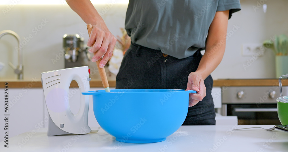 Woman mixing spinach with dough for healthy bakery, top view