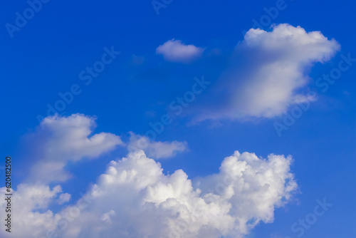 Group of white fluffy and soft clouds on blue sky. Background with copy space for meteorology presentation or natural and environment concept.