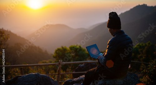 Fototapeta Naklejka Na Ścianę i Meble -  Traveller play laptop in morning with landscape view