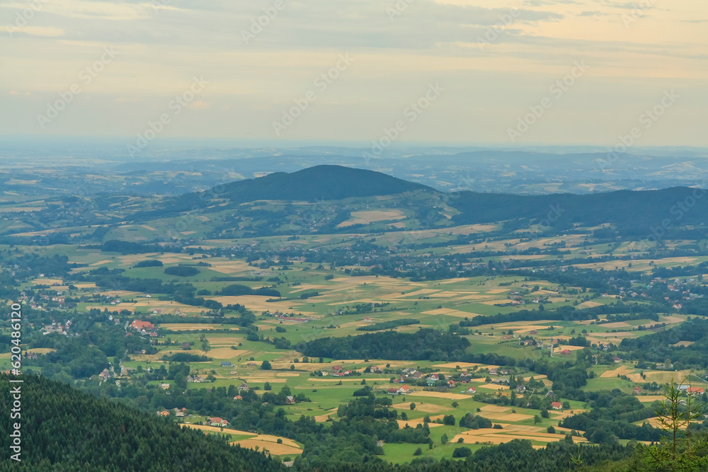 Panorama from the viewpoint under the Lubomir peak in Beskid Wyspowy (Poland) to the hills of Grodzisko (left) and Ksieza Góra on a sunny summer afternoon.