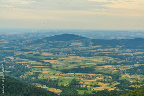 Panorama from the viewpoint under the Lubomir peak in Beskid Wyspowy (Poland) to the hills of Grodzisko (left) and Ksieza Góra on a sunny summer afternoon. © IwoiWo