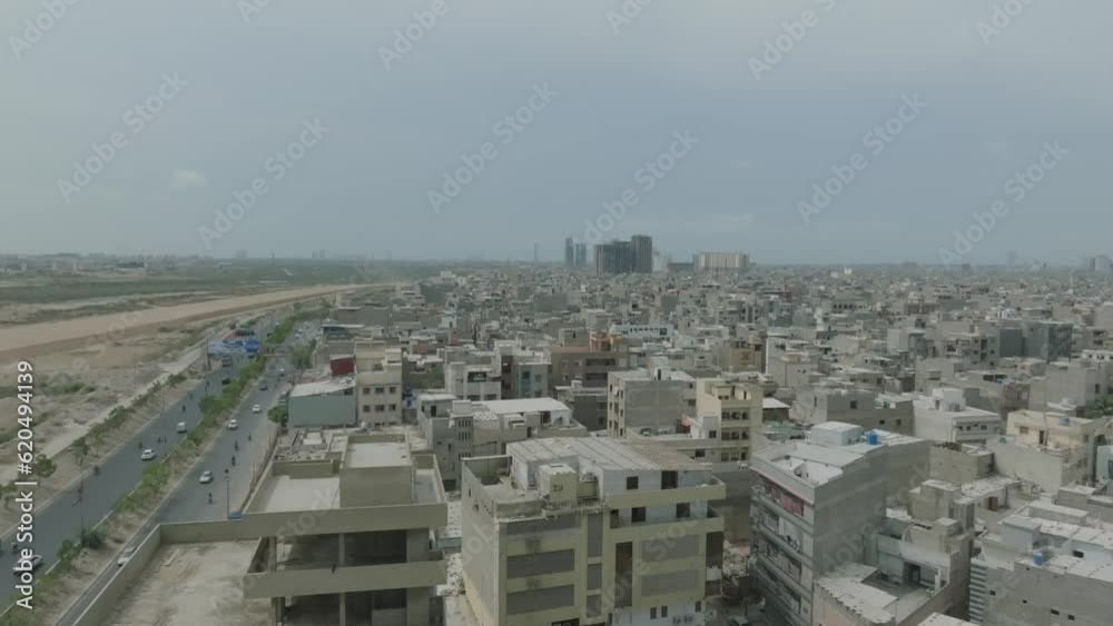 Aerial View Of Dense Urban Sprawl In Downtown Karachi Beside Highway. Dolly Left Shot Aerial View Of Dense Urban Sprawl In Downtown Karachi Beside Highway. Dolly Left Shot