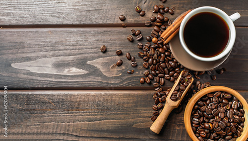 Coffee background, top view with copy space. Black cup of coffee, ground coffee, mill, bowl of roasted coffee beans on dark wooden background photo