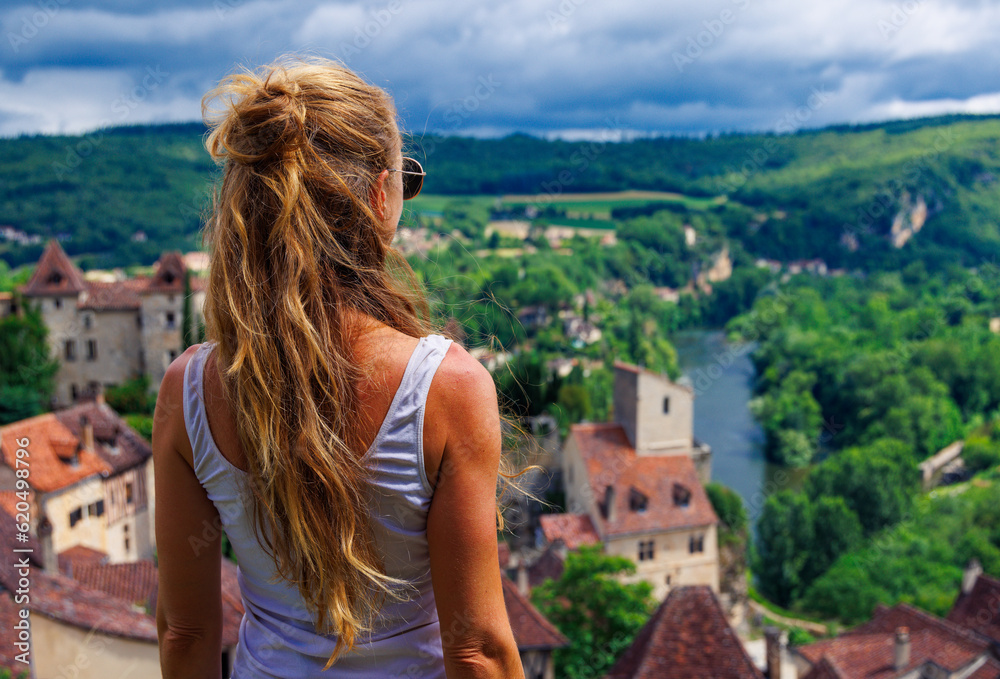 Woman enjoying panoramic view of Valley of Lot,  Saint Cirq Lapopie in France