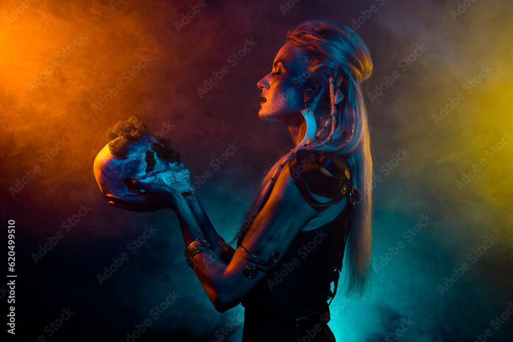 Photo of adorable attractive mystic woman wear gothic valkyrie costume praying skull isolated fog background