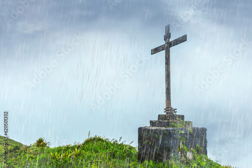 Christian cross in the rain in nature