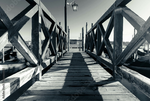 Wooden pontoon black and white on lagoon