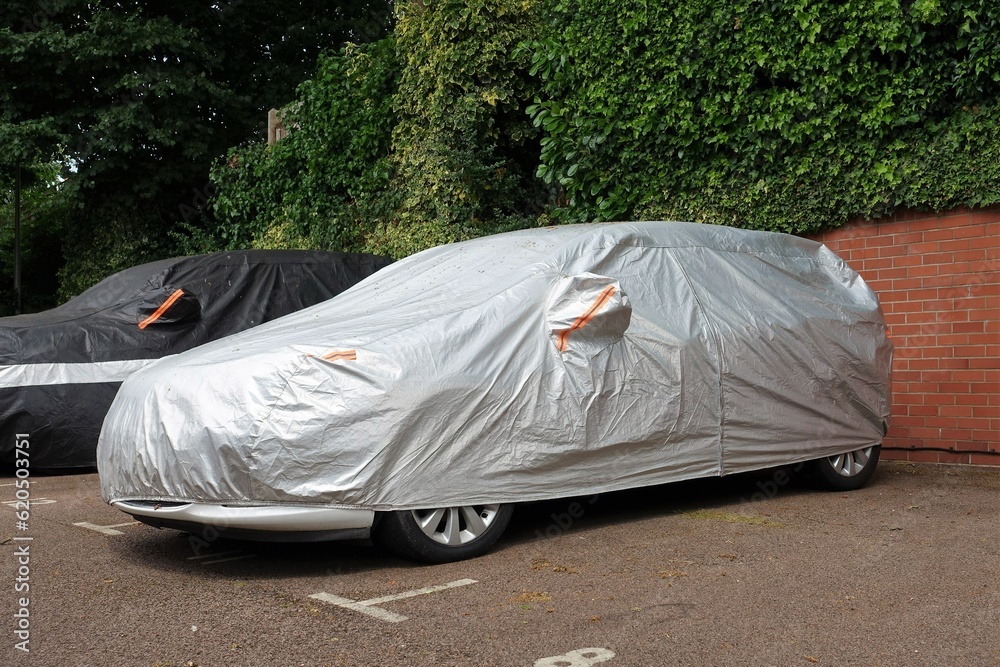 Vehicle under protective cover in parking space