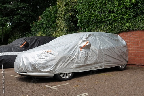 Vehicle under protective cover in parking space