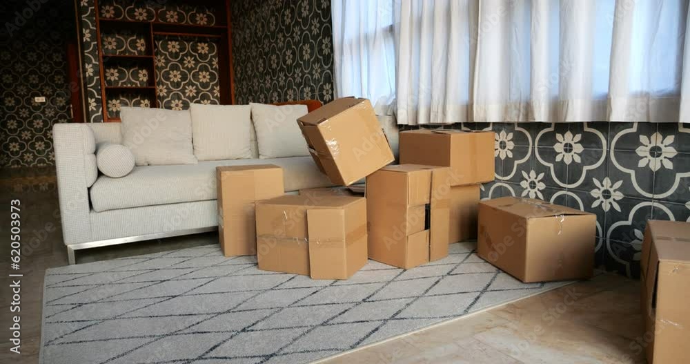 Scattered Boxes Scattered cardboard boxes in living room create messy pile. In slow ...