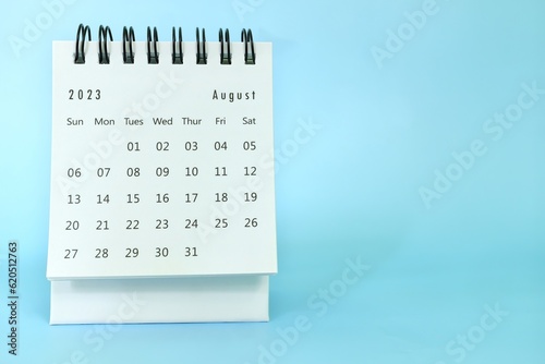 Selective focus of August 2023 desk calendar on blue background with copy space. 