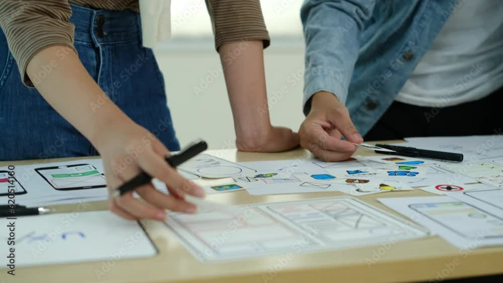 Mobile application, user and development. Team of designer brainstorming for mobile app interface wireframe design at office