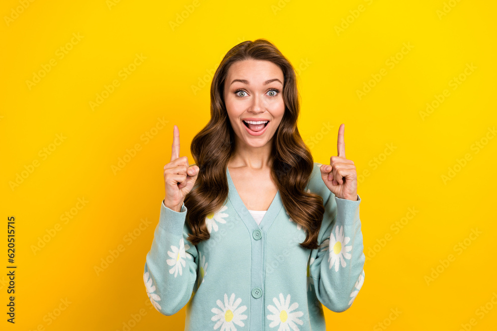 Photo of excited funky lady dressed teal cardigan open mouth pointing two fingers up emtpy space isolated yellow color background Photo of excited funky lady dressed teal cardigan open mouth pointing two fingers up emtpy space isolated yellow color background