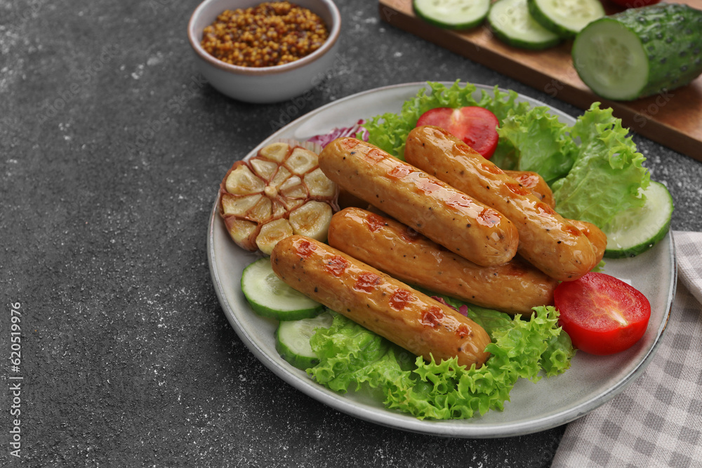 Delicious grilled vegan sausages with fresh herbs and vegetables on grey table, space for text Delicious grilled vegan sausages with fresh herbs and vegetables on grey table, space for text