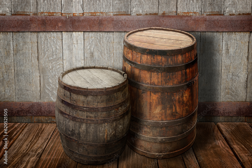 Wooden barrels on brown surface near textured wall Wooden barrels on brown surface near textured wall
