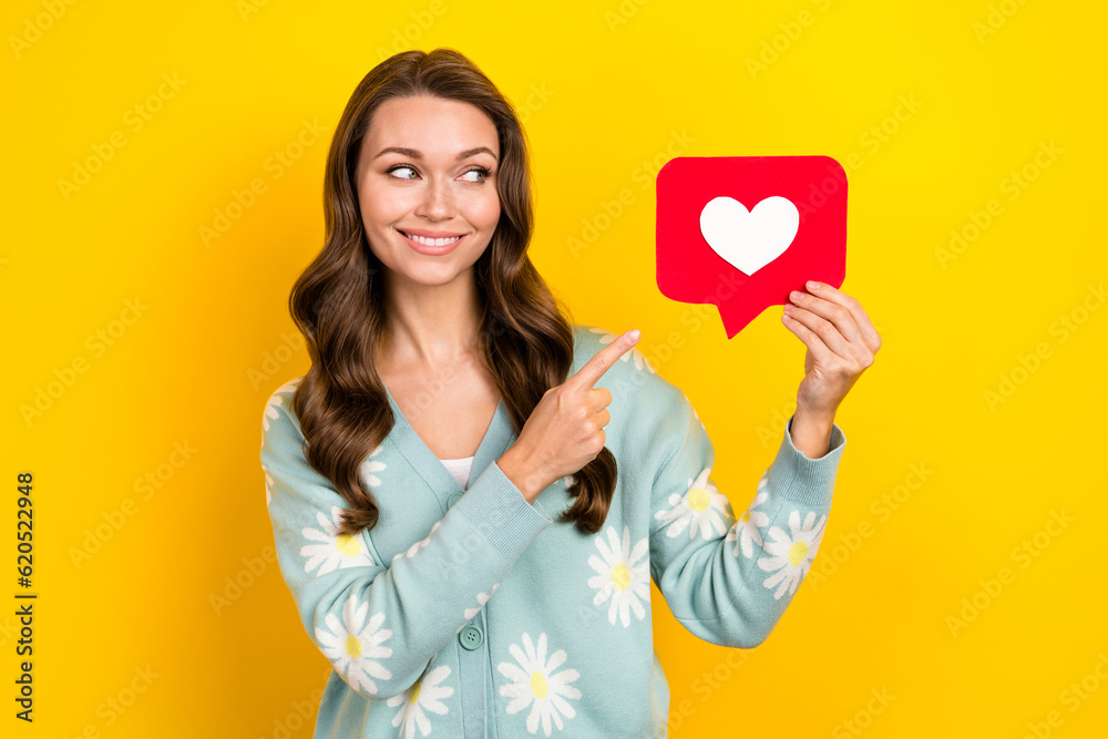 Portrait of gorgeous nice lady look direct finger arm hold paper like notification card isolated on yellow color background Portrait of gorgeous nice lady look direct finger arm hold paper like notification card isolated on yellow color background
