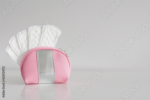 White daily cotton sanitary pads for hygiene protection in travel cosmetic bag