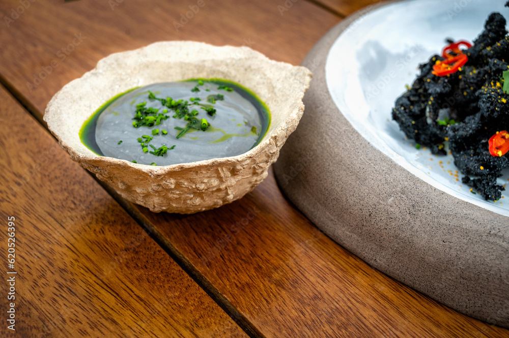 An exquisite example of haute cuisine, this small bowl resembles a stone and contains a delightful green sauce An exquisite example of haute cuisine, this small bowl resembles a stone and contains a delightful green sauce