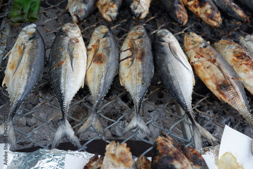 Grilled mackerel lined up on the grill. Grilled mackerel lined up on the grill.