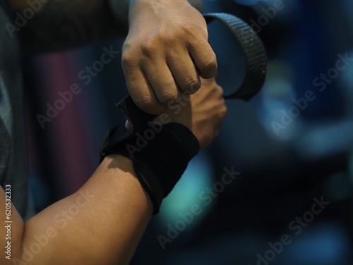 hands men holding and putting arm wrap bandages weight kilograms, arm dumbbell, fitness, gym, training, power, sport, health, exercise, fighter