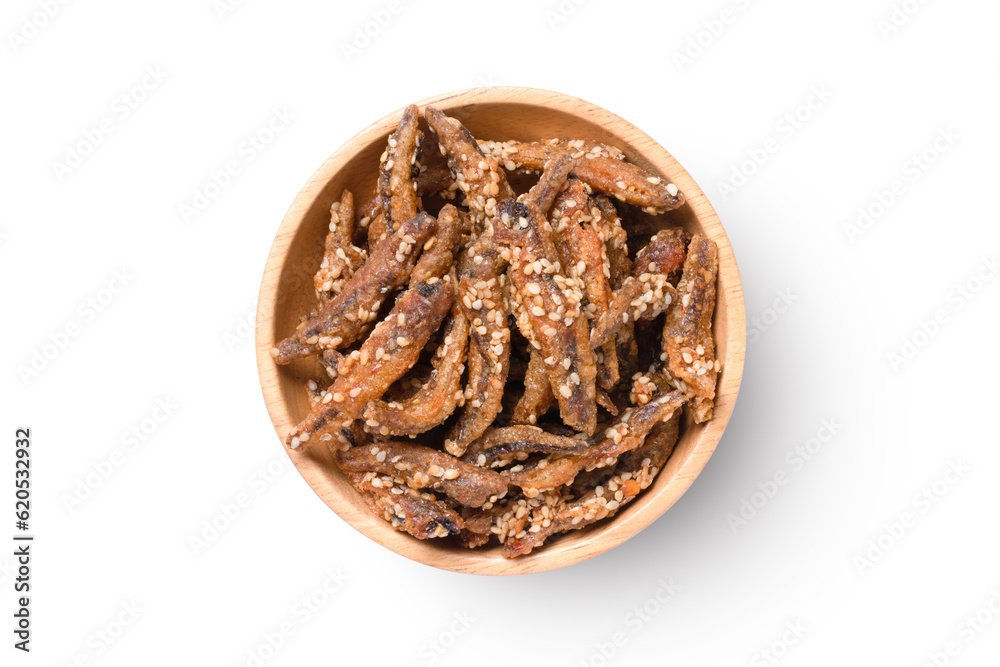 Crispy fish (anchovy) in wooden bowl isolated on white background with clipping path, top view, flat lay. Crispy fish (anchovy) in wooden bowl isolated on white background with clipping path, top view, flat lay.