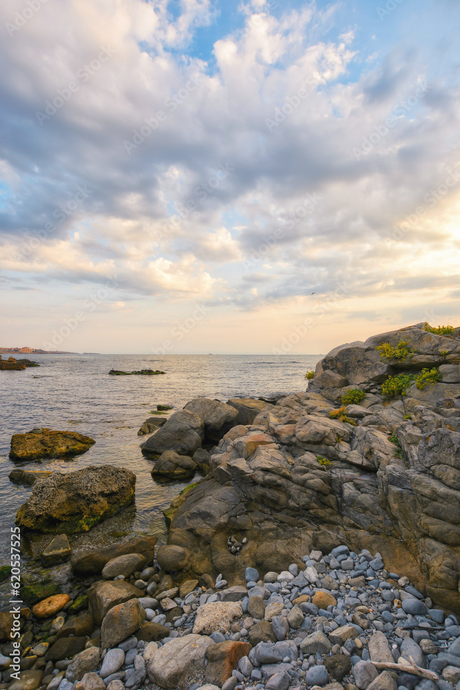 pebble coast at sunrise. gorgeous view of seascape on a cloudy morning. relax and recreation at the sea pebble coast at sunrise. gorgeous view of seascape on a cloudy morning. relax and recreation at the sea