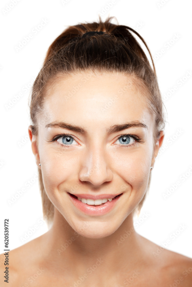 Obraz premium Beautiful girl with blue eyes close up beauty portrait. Smiling and looking at camera.
