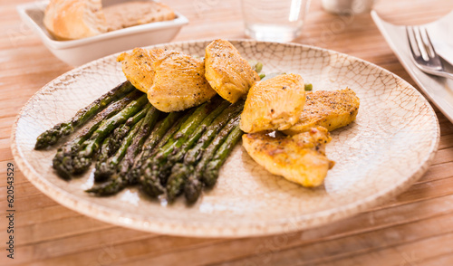 dietary meal rich in protein. Stir fried chicken breast and green asparagus