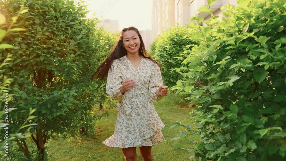 Happy asian woman in romantic dress runs Happy asian woman in romantic dress runs