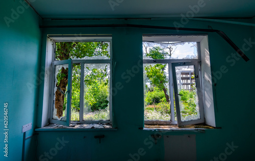 empty window of a destroyed house in Ukraine photo
