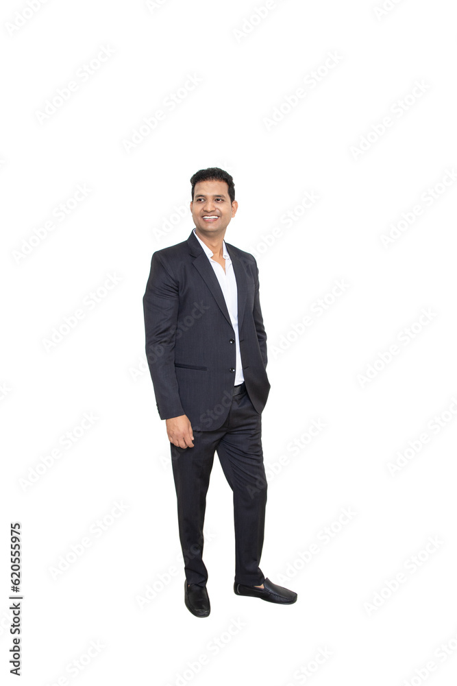 Smiling handsome young indian businessman wearing suit standing looking at camera isolated over white background. Corporate Concept. Smiling handsome young indian businessman wearing suit standing looking at camera isolated over white background. Corporate Concept.