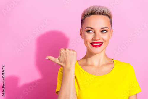 Portrait of nice positive girl look indicate thumb finger empty space offer isolated on pink color background