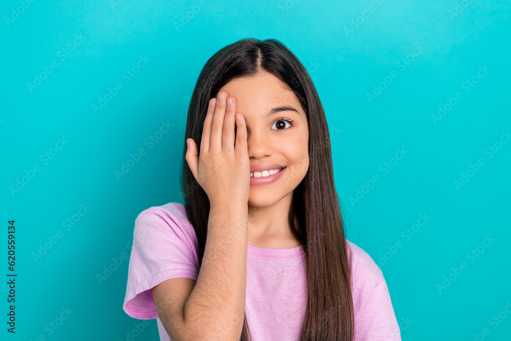 Portrait of funny smile schoolgirl good mood vision checkup ophthalmology healthy wearing pink t-shirt isolated on cyan color background Portrait of funny smile schoolgirl good mood vision checkup ophthalmology healthy wearing pink t-shirt isolated on cyan color background