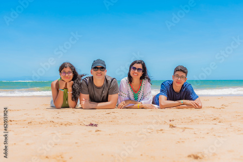 Família deitada na praia photo