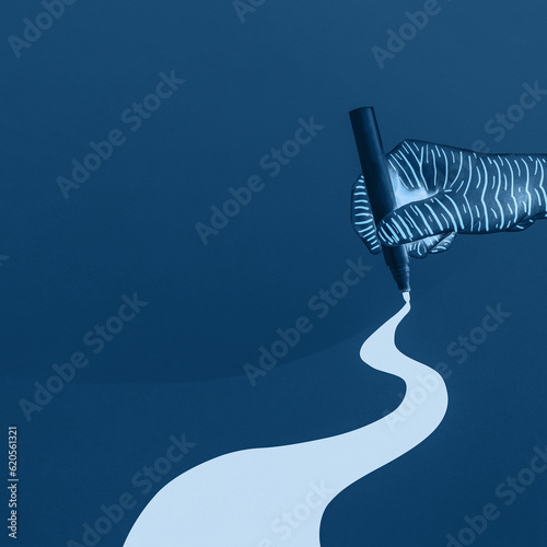 Concept of artist line design and scribbles on the prussian blue background. Hand drawing curve road. A winding path way that leads forward.