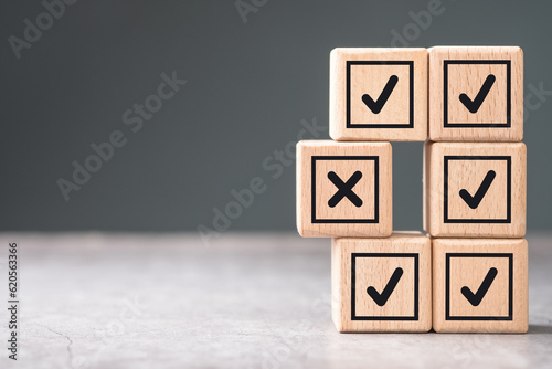Photography Stacks of wood cubes with correct marks, but the only wrong one is sticking out,