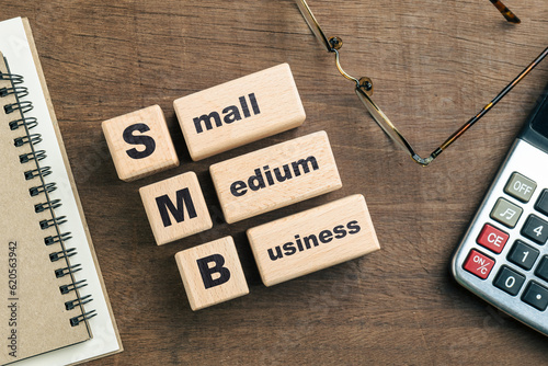 Photography SMB, Small and medium business text on wood blocks on the desk, with part of cal
