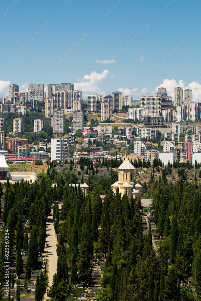 Fototapeta premium Saburtalo Vake district in Tbilisi, Georgia on a sunny summer day with beautiful clouds.