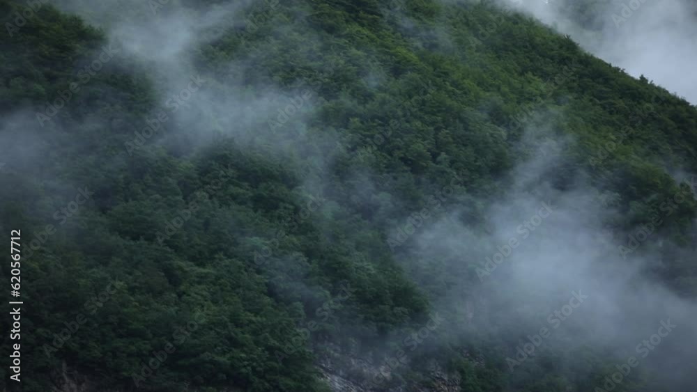 Low clouds in the mountains. Panoramic view of low fog in mountainous area. Mist on the green slopes of the hills. summer travel. hiking in Montenegro. Low clouds in the mountains. Panoramic view of low fog in mountainous area. Mist on the green slopes of the hills. summer travel. hiking in Montenegro.