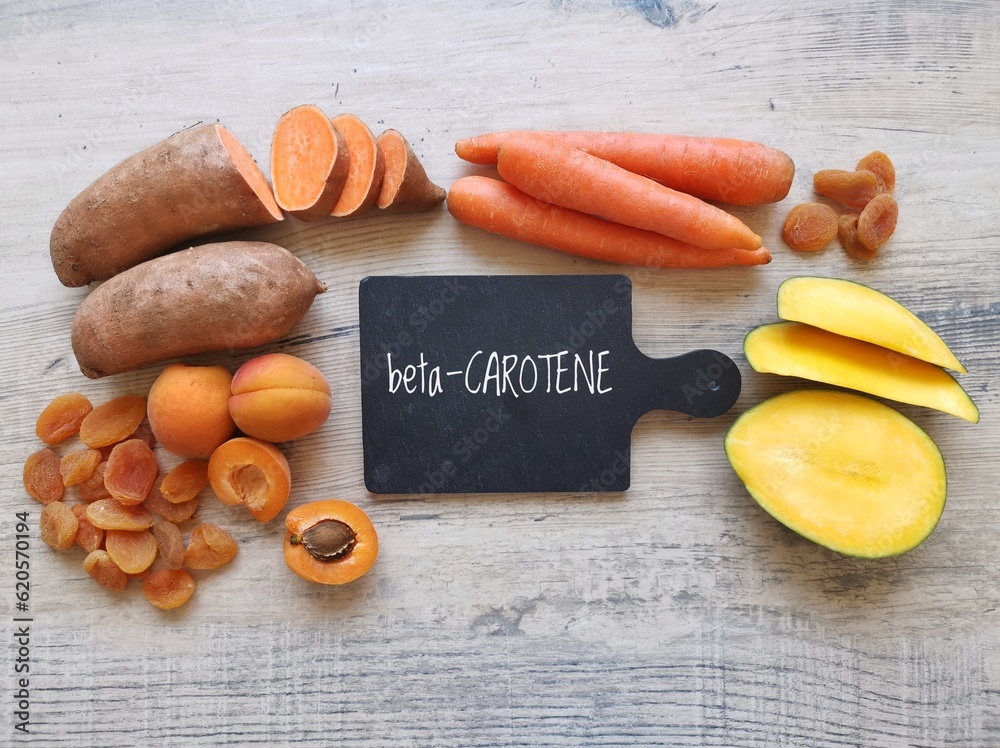 Food rich in beta carotene with text Beta Carotene. Various fruits and vegetables as natural