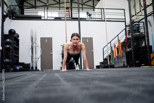 Asian woman exercising in the gym happy smile fitness concept.