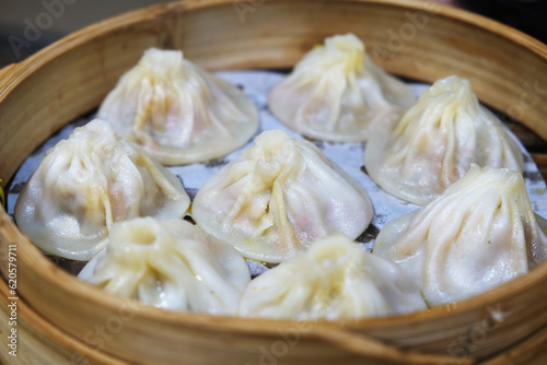 several Chinese Tangbao (soup buns) in bamboo steamer. soup-filled steamed buns (baozi) in China