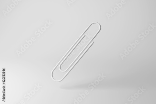 White paper clip on white background in monochrome and minimalism. Illustration of the concept of office stationary and document filing